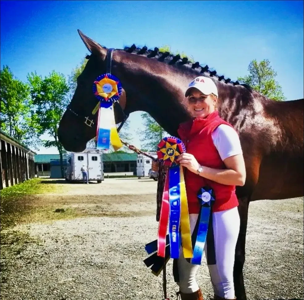 Hemmingway OLD with rider holding competition ribbons